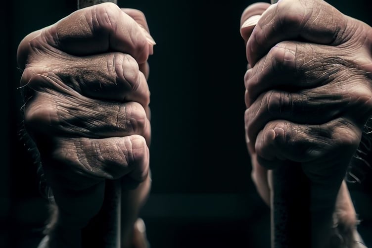 Hands on jail cell bars