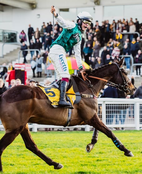 Charlie Deutsch salutes after victory at Cheltenham. Photo Cheltenham Racecourse