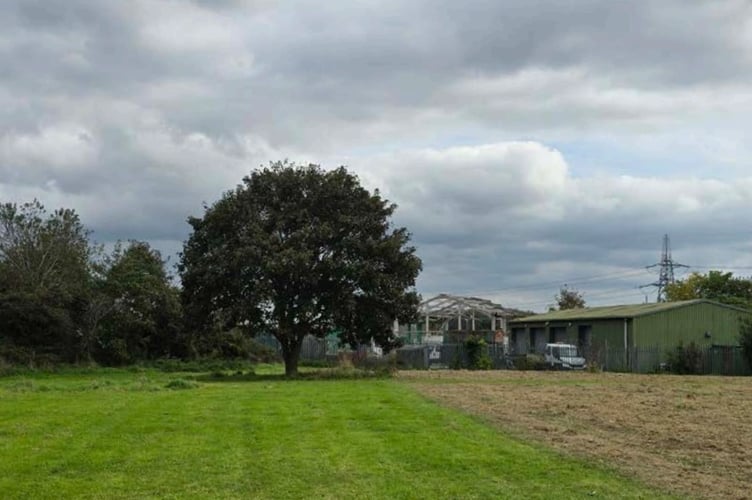 A view across the recreation ground, towards the existing Pil Row depot, with the Sycamore tree that is to be retained on the left. 