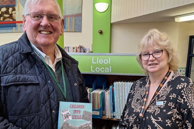 John Crook, councillor for Magor East with Undy on Monmouthshire County Council, and librarian Fiona Ashley with ‘Children into Exile’ by Peter Hayward