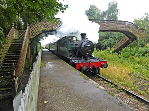 A steam train passes under St Mary's Halt bridge
