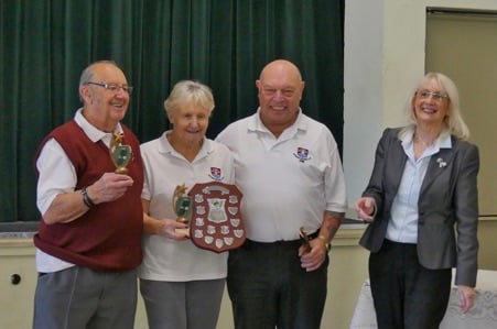 The winning triple from Usk SMBC receiving their trophies from MSMBA Chair, Philomena Vaughan. L-R: Ralph Berry (Skip), Pat Cullimore (Lead), Phil Radley (2). Photo credit: Colin Berg
