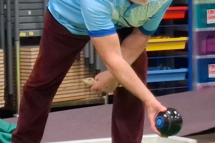 A Dingestow player prepares to deliver a bowl