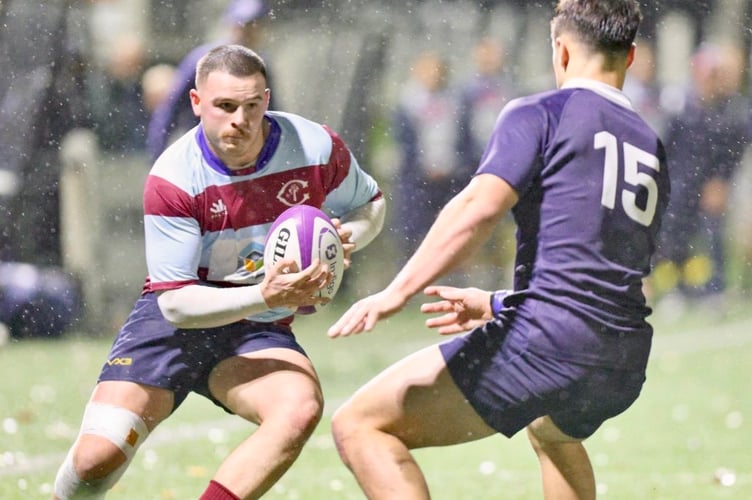 ????? takes on the Oxford full-back as the rain falls